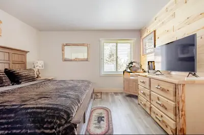 a bedroom with a bed and a flat screen tv at Mammoth Creek 29 in Mammoth Lakes