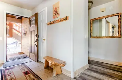 a hallway with a mirror and a bench at Mammoth Creek 29 in Mammoth Lakes
