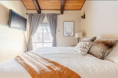 a bedroom with a large white bed and a window at Mammoth Estates 138 in Mammoth Lakes