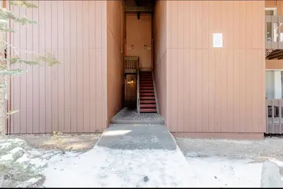 a stairway leading to a pink building with a door at Mammoth Estates 138 in Mammoth Lakes