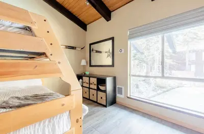 a bedroom with bunk beds and a large window at Mammoth Estates 138 in Mammoth Lakes