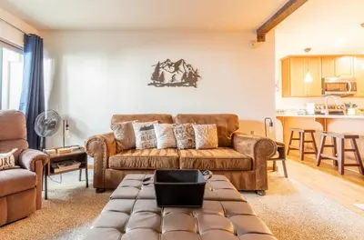 a living room with a couch and a table at Chamonix 17 in Mammoth Lakes