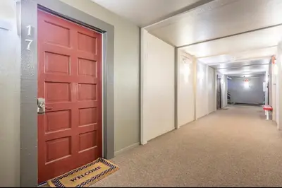 a red door leading into a hallway with a hallway at Chamonix 17 in Mammoth Lakes