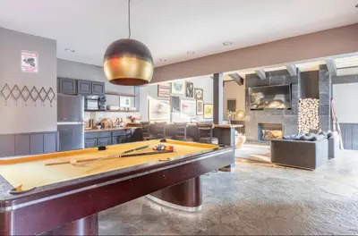 a pool table in the middle of a living room at Chamonix 17 in Mammoth Lakes