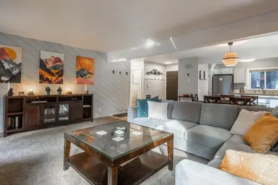 a living room with a couch and a table at Wildflower 65 in Mammoth Lakes