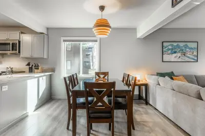 a kitchen and dining room with a table and a couch at Wildflower 65 in Mammoth Lakes