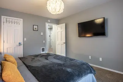 a living room with a tv on a wall at Wildflower 65 in Mammoth Lakes