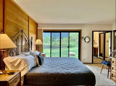 a bedroom with a large bed and a large window at Snowcreek 290 in Mammoth Lakes
