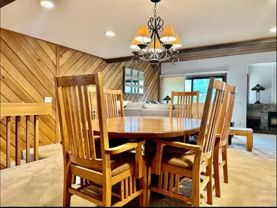 a dining room with a wooden table and chairs at Snowcreek 290 in Mammoth Lakes