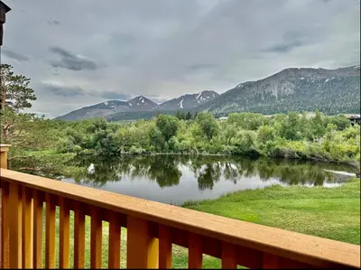 a view of a river from a wooden deck at Snowcreek 290 in Mammoth Lakes