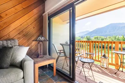 a porch with a couch and a table on a deck at Snowcreek 290 in Mammoth Lakes
