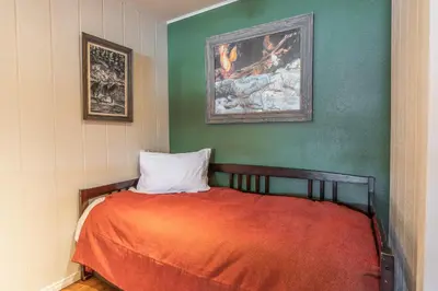 a bedroom with a bed and a painting on the wall at Summit 33 in Mammoth Lakes