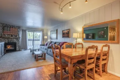 a living room with a table and a couch at Summit 33 in Mammoth Lakes