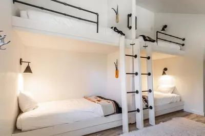 a bedroom with two bunk beds and a couch at San Sierra 19 in Mammoth Lakes