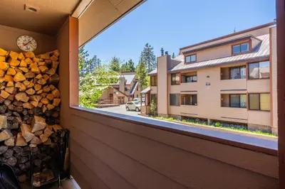 a room with a window and a pile of fire wood at San Sierra 19 in Mammoth Lakes