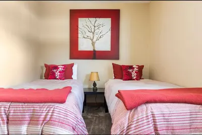 two beds in a room with red and white sheets at Gray Eagle 5 in Mammoth Lakes