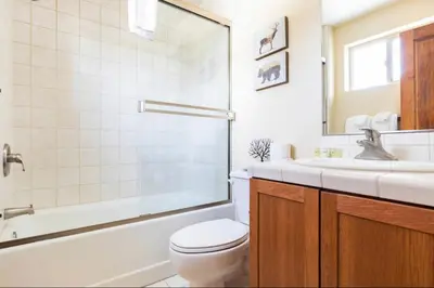 a bathroom with a toilet and a tub and a sink at Gray Eagle 5 in Mammoth Lakes