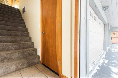 a staircase with a wooden door next to a building at Gray Eagle 5 in Mammoth Lakes