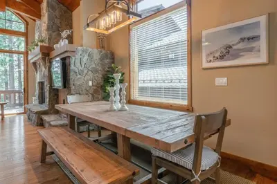 a dining room with a wooden table and a window at Stonegate 11 in Mammoth Lakes