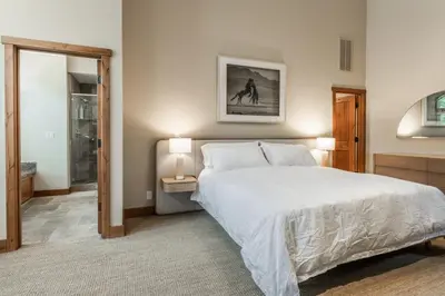 a bedroom with a large white bed and two lamps at Stonegate 11 in Mammoth Lakes