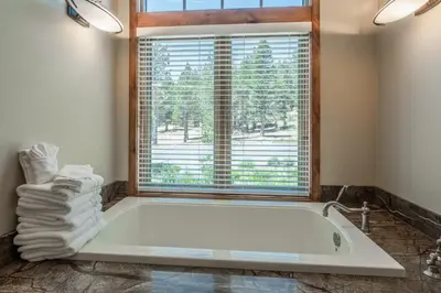 a bath tub in a bathroom with a window at Stonegate 11 in Mammoth Lakes
