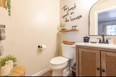 a bathroom with a toilet and a sink and a mirror at Seasons Four 165 in Mammoth Lakes