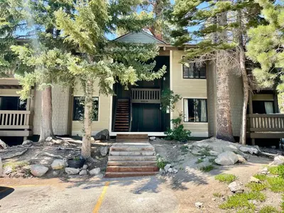 a house with trees and stairs in front of it at Seasons Four 165 in Mammoth Lakes