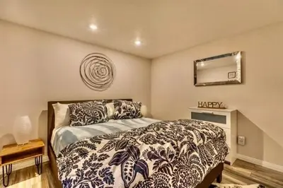 a bedroom with a bed and a mirror on the wall at Bigwood 5 in Mammoth Lakes