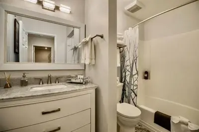 a bathroom with a sink and a toilet and a mirror at Bigwood 5 in Mammoth Lakes