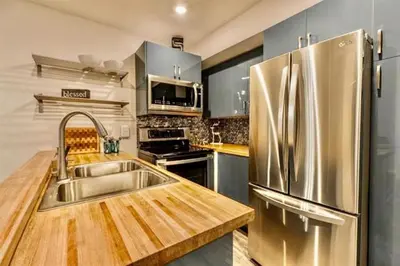 a kitchen with a stainless steel refrigerator and a sink at Bigwood 5 in Mammoth Lakes