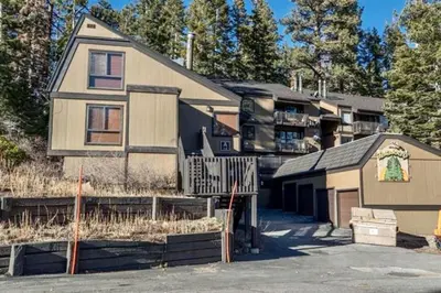 a house with a parking lot in front of a building at Bigwood 5 in Mammoth Lakes