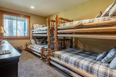 a bedroom with three bunk beds in a room at Timbers 1031 in Mammoth Lakes