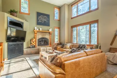 a living room with leather furniture and a fireplace at Timbers 1031 in Mammoth Lakes