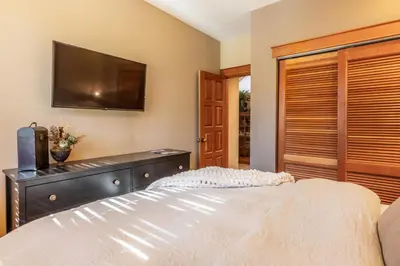 a bedroom with a bed and a flat screen tv at Timbers 1031 in Mammoth Lakes
