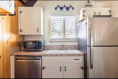 a kitchen with a sink and a refrigerator at Mammoth View Villas 20 in Mammoth Lakes