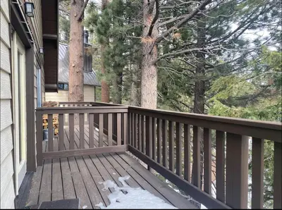 a wooden deck with snow on the floor of a house at Mammoth View Villas 20 in Mammoth Lakes