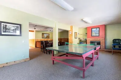 a ping pong table in the middle of a room at Mammoth View Villas 20 in Mammoth Lakes
