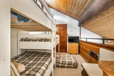 a bedroom with two bunk beds in a house at Canyon Ski and Racquet 3 in Mammoth Lakes