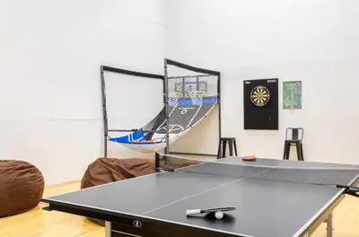 a ping pong table in a room with a ping pong racket at Canyon Ski and Racquet 3 in Mammoth Lakes