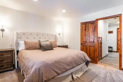 a bedroom with a large bed and a wooden door at Winterset 20 in Mammoth Lakes