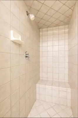 a bathroom with a shower with white tiles at Seasons Four 193 in Mammoth Lakes