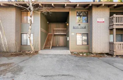a house with a porch and a staircase on the front at Seasons Four 193 in Mammoth Lakes
