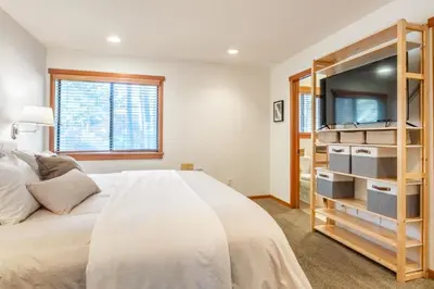 a bedroom with a bed and a tv at Snowflower 21 in Mammoth Lakes