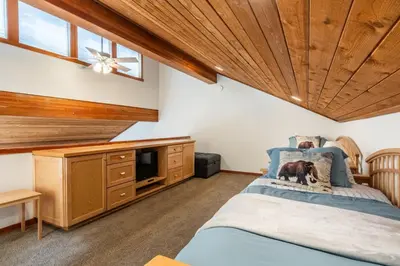 a bedroom with a bed with a dog on it at Snowflower 21 in Mammoth Lakes