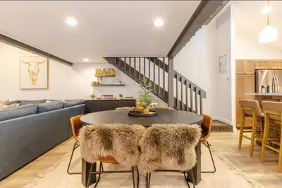 a living room with a table and a couch at Snowcreek 25 in Mammoth Lakes