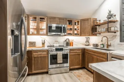 a kitchen with wooden cabinets and a stainless steel refrigerator at Snowcreek 25 in Mammoth Lakes