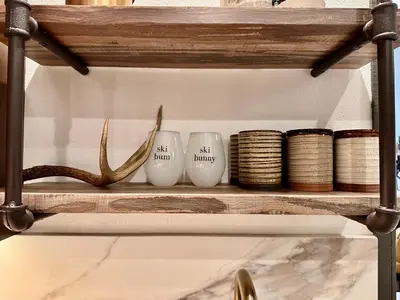 a shelf with two antlers and three white vases at Snowcreek 25 in Mammoth Lakes