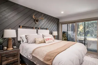a bedroom with a large bed and a large window at Snowcreek 25 in Mammoth Lakes