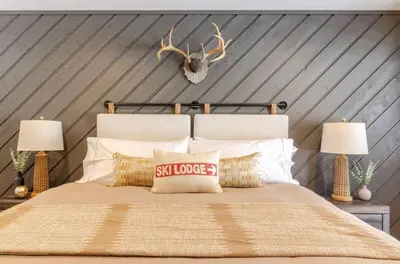 a bedroom with a bed with antlers on the wall at Snowcreek 25 in Mammoth Lakes