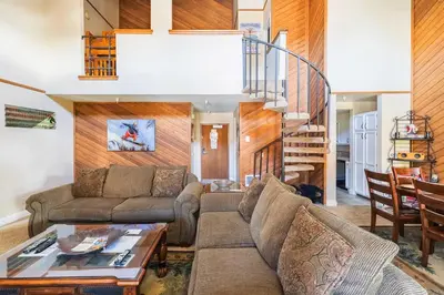 a living room with a couch and a table at Aspen Creek 219 in Mammoth Lakes